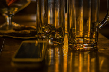 A mug for beer on a wooden table.