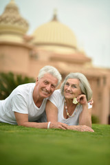 Elderly couple posing on grass