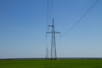 Fototapeta na wymiar High voltage power line against blue sky