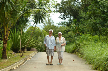 Fototapeta na wymiar elderly couple rest at tropical beach