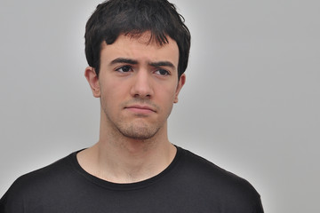 portrait of a frowning young man on a white background