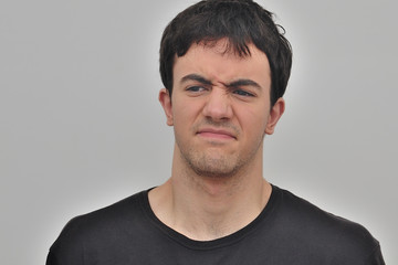 Fototapeta premium portrait of a frowning young man on a white background