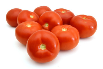 Closeup of tomatoes on the vine isolated on white