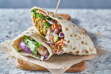 vegan food- tasty falafel wrap in gluten free bread - obrazy, fototapety, plakaty
