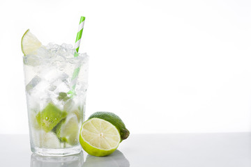 Caipirinha cocktail in glass on white background. Copyspace

