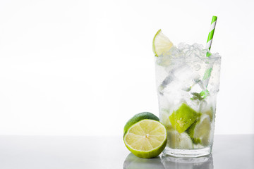 Caipirinha cocktail in glass on white background. Copyspace

