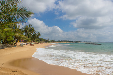 Beautiful beach. View of nice tropical beach with palms around. Holiday and vacation concept. Tropical beach.