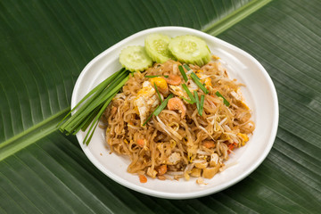 Fried Rice Sticks with Shrimp in white dish on banana leaf