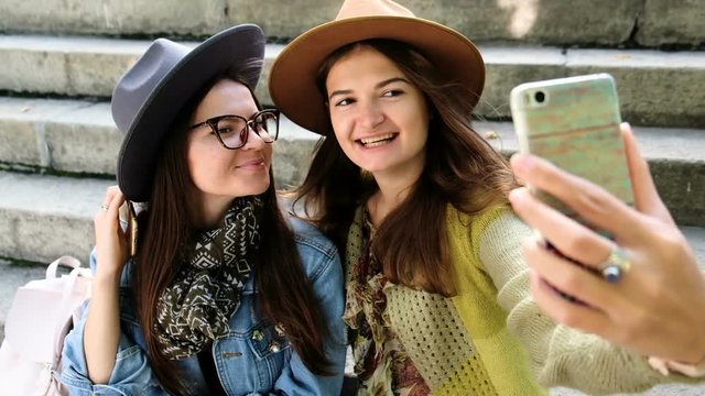 young women having fun and taking selfies close up