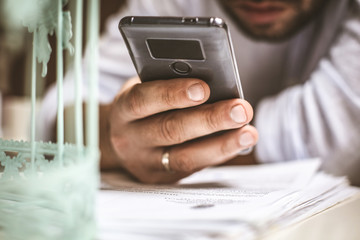 Businessman using mobile phone. Focus on phone.