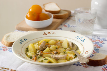 Stew or roast or soup with meat and potatoes, served with canned tomatoes and bread.
