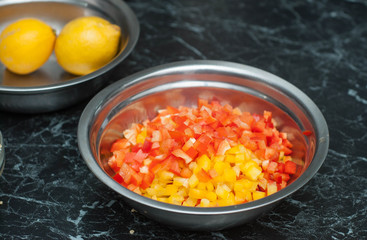 Chopped Bell Peppers in a Metal Bowl. Food Preparing Process at the Restaurant Kitchen. Vegan and Healthy Food Concept.