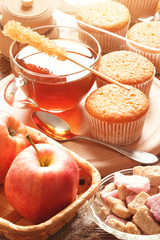 Lunch with apples, tea, sugar and cupcakes