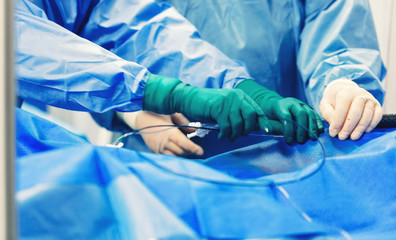Team of cardiologist minimally invasive cardiology transcatheter closure treatment for patent foramen ovale PFO defects with occluder, using a endovascular procedure with cardiovascular imaging system
