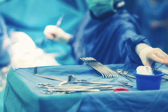 Surgical operating room with equipment for cardiovascular emergency surgery center. Surgery medical clinic with clamps, forceps and surgeons for open heart microsurgery and electrocautery.
