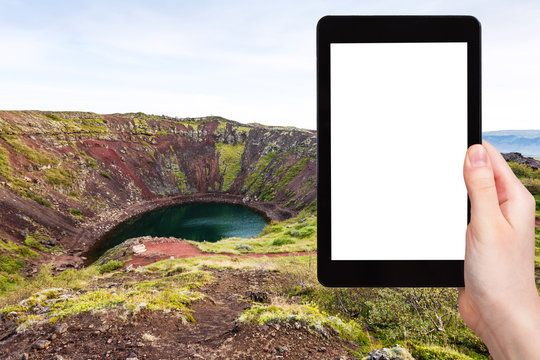 tourist photographs crater with Kerid lake