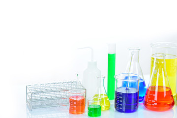 Laboratory glassware with colorful chemical reagent in research laboratory 
