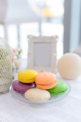 Tasty beautiful macaroons on a beautiful table in the style of Provence.