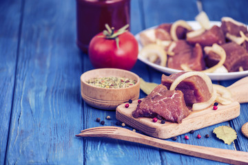 marinated pork meat for a barbecue on a wooden board