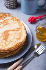 Traditional Russian pancakes with honey. Shrovetide. Maslenitsa week. Selective focus, close-up.