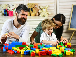 Young family spends time in playroom. Love and family games
