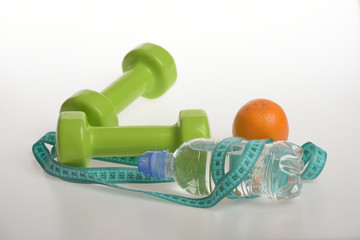 Athletics and weight loss concept. Dumbbells in green color