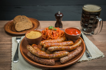 Assorted fried sausages, stewed cabbage and beer. 