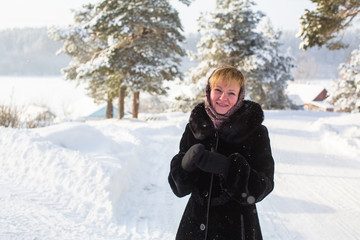 Young woman in the winter at snowy park.