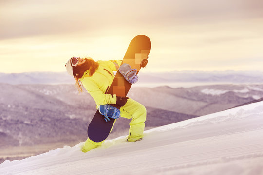 Happy lady snowboarder having fun with snowboard