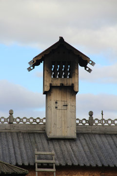 Сhimney of the Russian wooden house with traditional woodcarving.