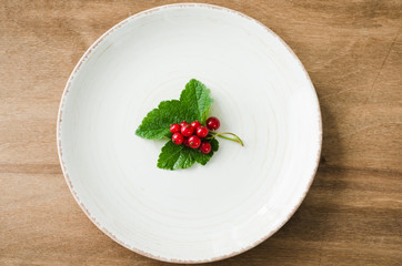 Fresh ripe organic red currant in plate.