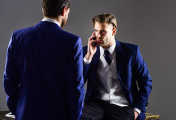 Man in classic suit or businessman with smartphone or mobile