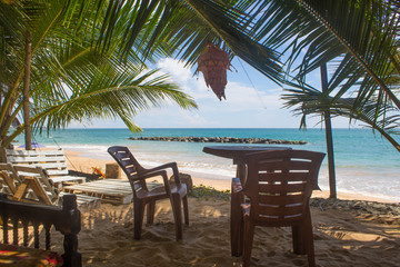Beautiful beach. View of nice tropical beach with palms around. Holiday and vacation concept. Tropical beach.