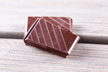 Chocolate blocks over wooden table