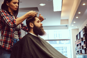 Handsome bearded man in the barbershop.