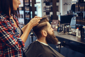 Handsome bearded man in the barbershop.