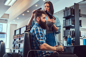 Handsome bearded man in the barbershop.