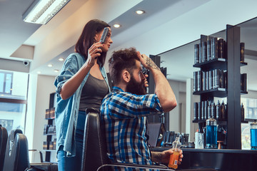 Handsome bearded man in the barbershop.