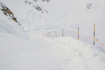 5km long red piste from Gemsstock peak in SkiArena skiing resort