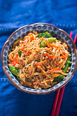 Sichuan spicy pork noodles with bean sprouts, sugar snap peas and oak choi
