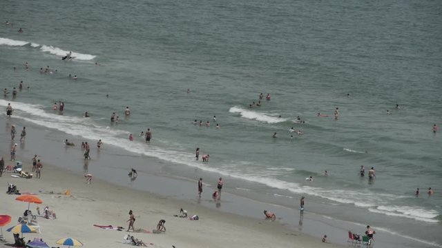 1820 People Enjoying the Beach with Ocean Waves in Slow Motion