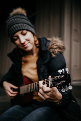 Fototapeta na wymiar Girl with guitar in the woods
