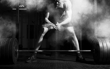 Weightlifter clapping hands and preparing for workout at a gym