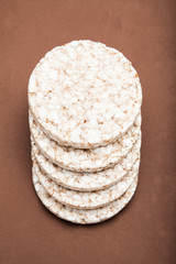 Gluten free food. Rice crispy on brown background.