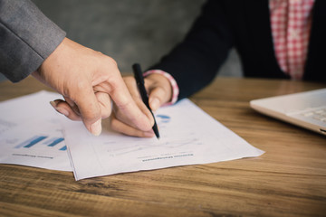 Asian business people talking about report and working with paper sheet color hipster tone