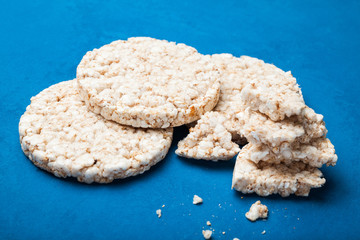 Close up of puffed snack with crumbs.