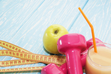 Fototapeta na wymiar The concept of a healthy diet. Small dumbbells, juice. Apples. healthy lifestyle. sport. Fitness food.