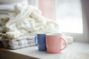 Two cups of different colors resemble different people. Different but very close.