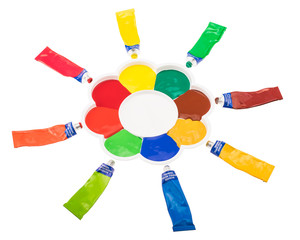 Flower shaped art palette with multicolored tubes of paint