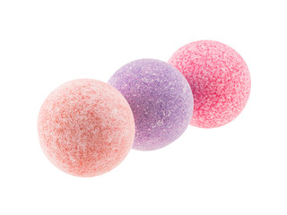 Three spotted bath bombs isolated over white